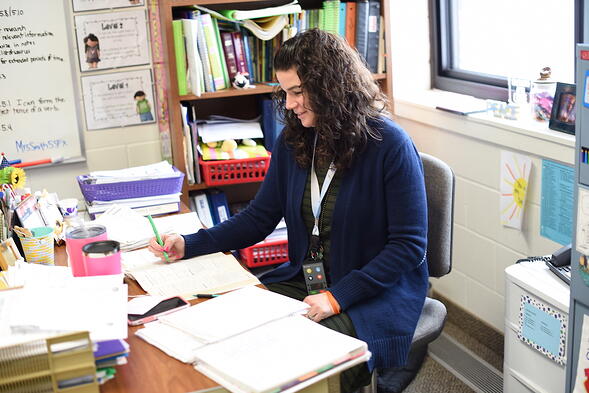 Image of a woman writing in a notebook