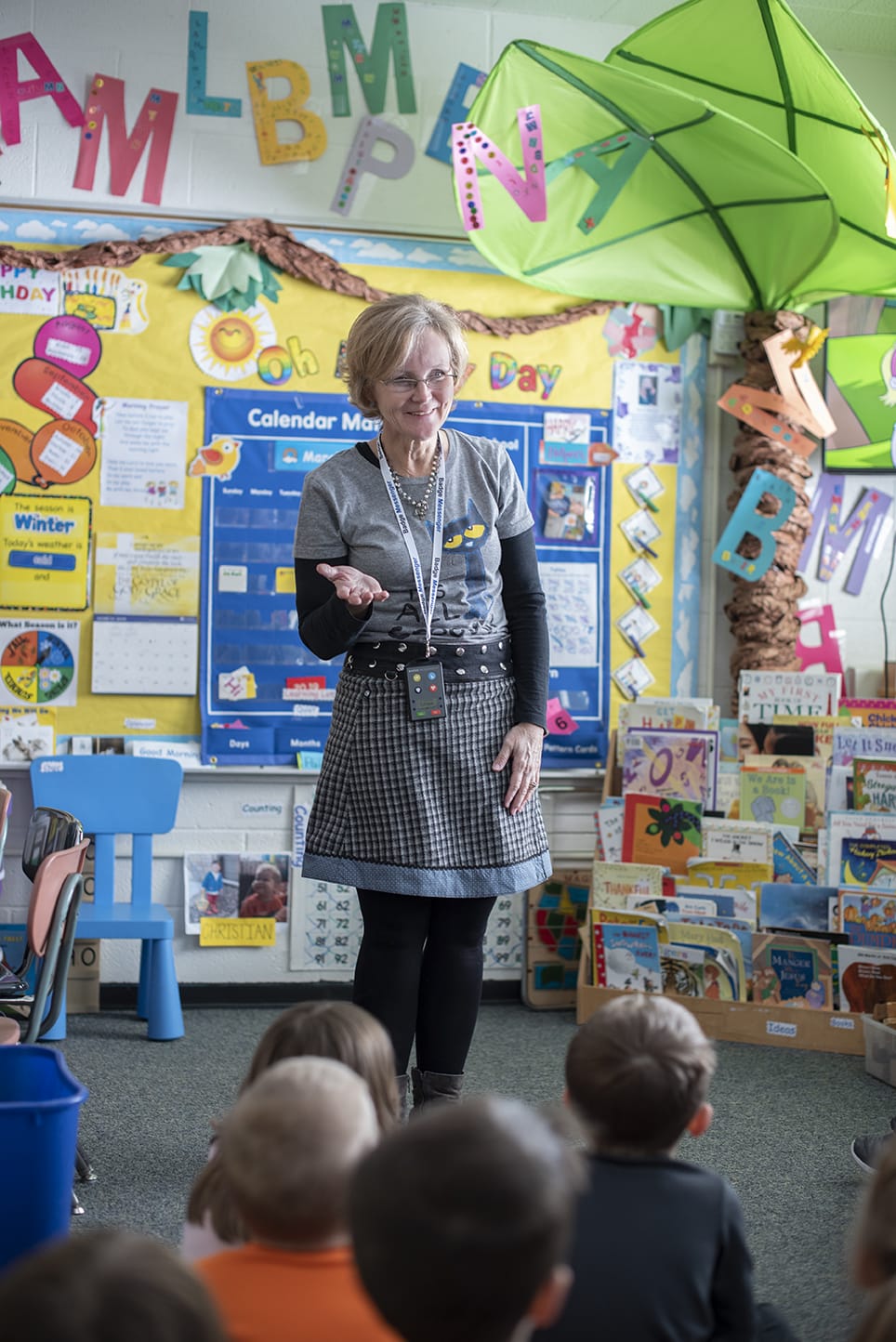 teacher standing in front of her students wearing Badge Messenger