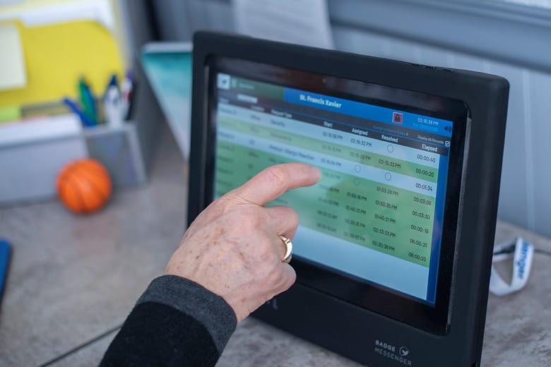 Image of a man touching the Badger Messenger screen